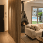 Entrée de maison chaleureuse avec tasseaux de bois, poêle design et canapé beigne